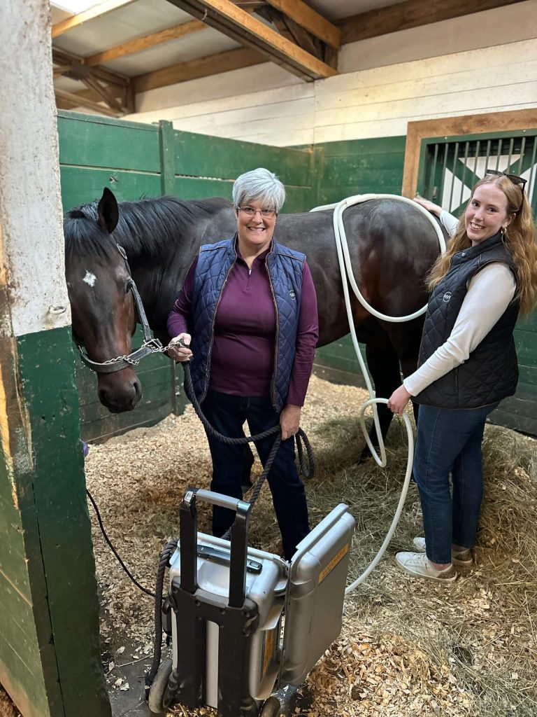 MagnaWavePEMF Carson and Joanne using PEMF Therapy on a horse's haunches in a stable. Using the XL Wave Wings PEMF attachment